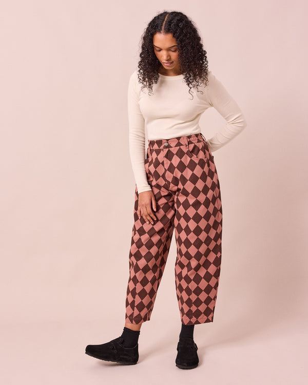 model wears remi clay pink and chocolate harlequin denim jeans right