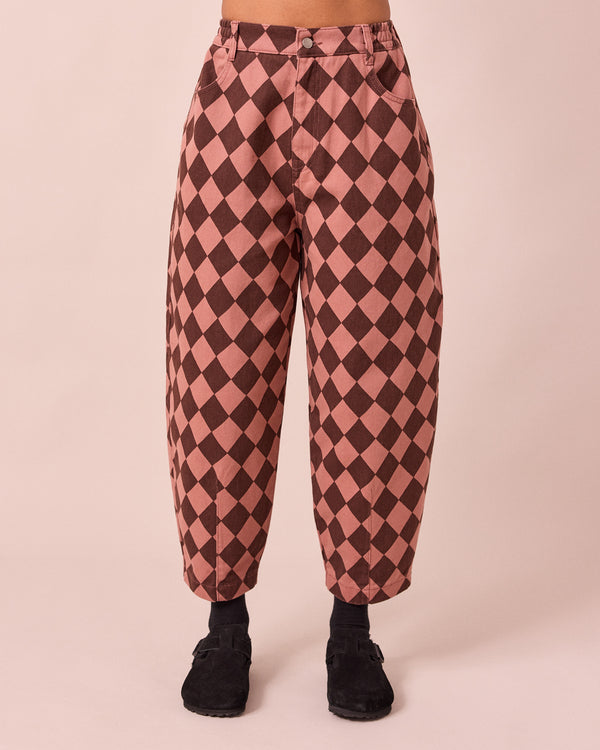 model wears remi clay pink and chocolate harlequin denim jeans front