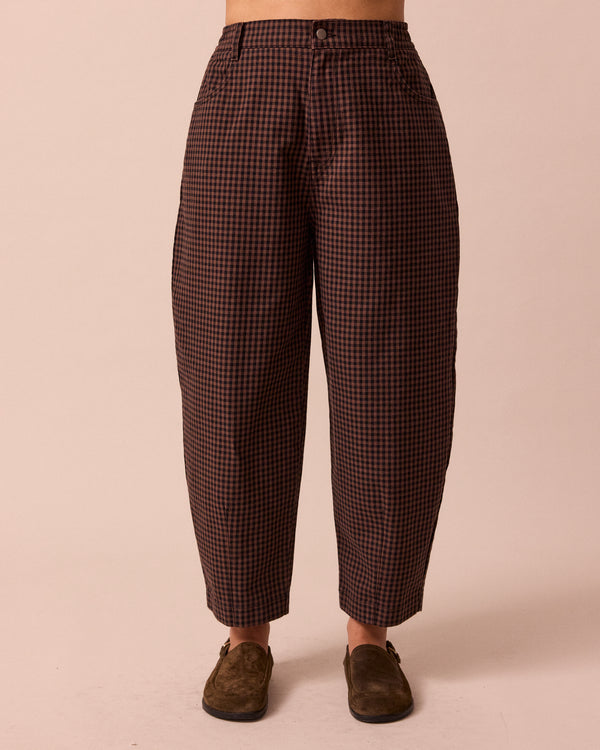 model wears remi cocoa gingham denim jeans front