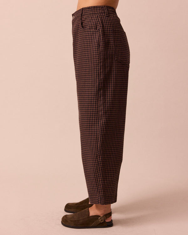 model wears remi cocoa gingham denim jeans left