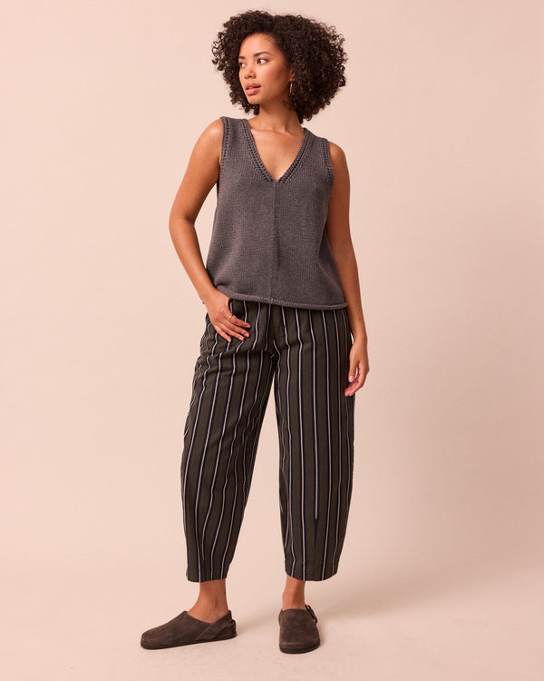 model wears remi dark fern stripe denim jeans left