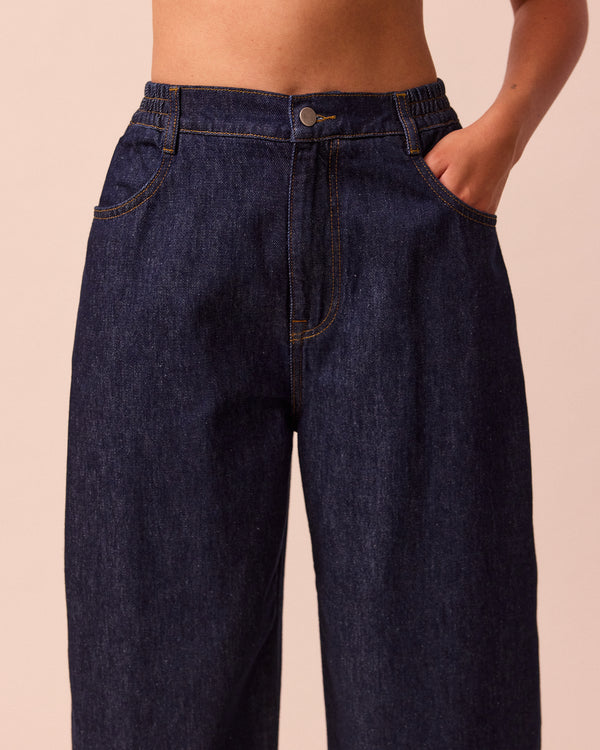 model wears remi indigo rinse wash denim trousers 