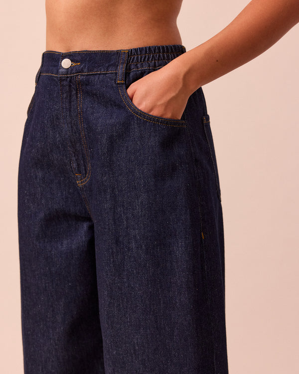 model wears remi indigo rinse wash denim jeans right