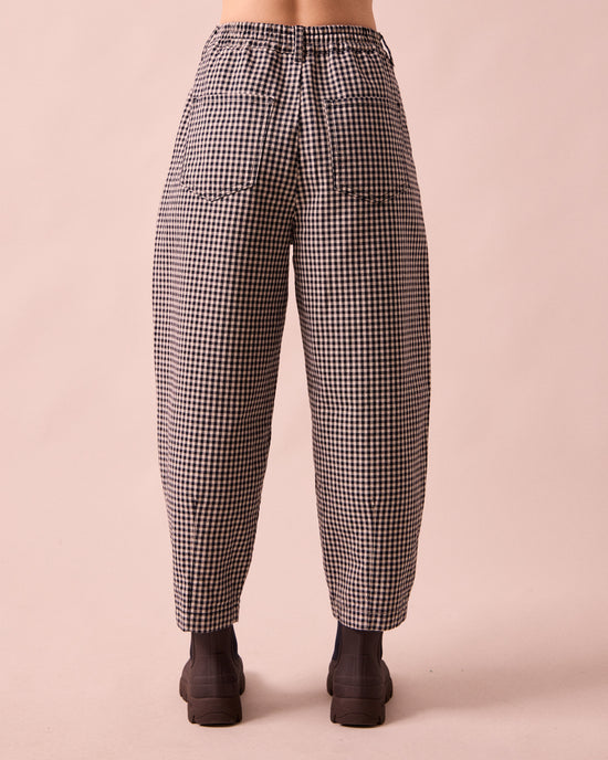 model wears remi black and white mini gingham denim jeans back