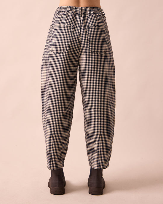 model wears remi black and white mini gingham denim jeans back