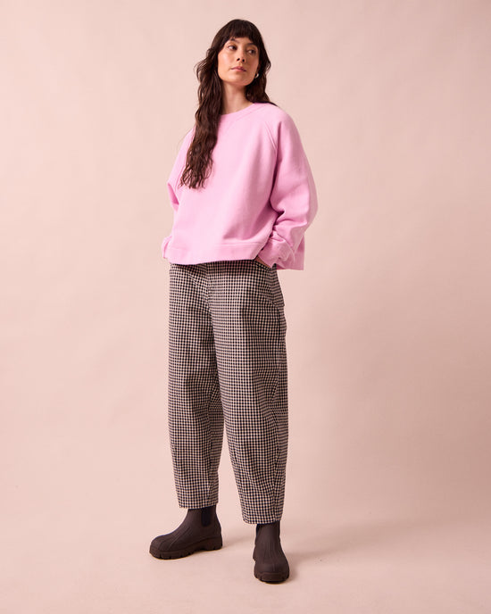 model wears remi black and white mini gingham denim jeans right