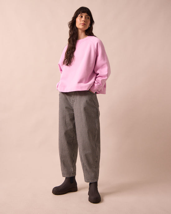 model wears remi black and white mini gingham denim jeans right