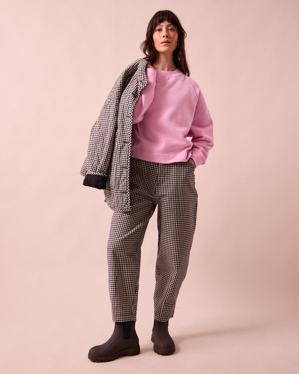 model wears remi black and white mini gingham denim jeans left