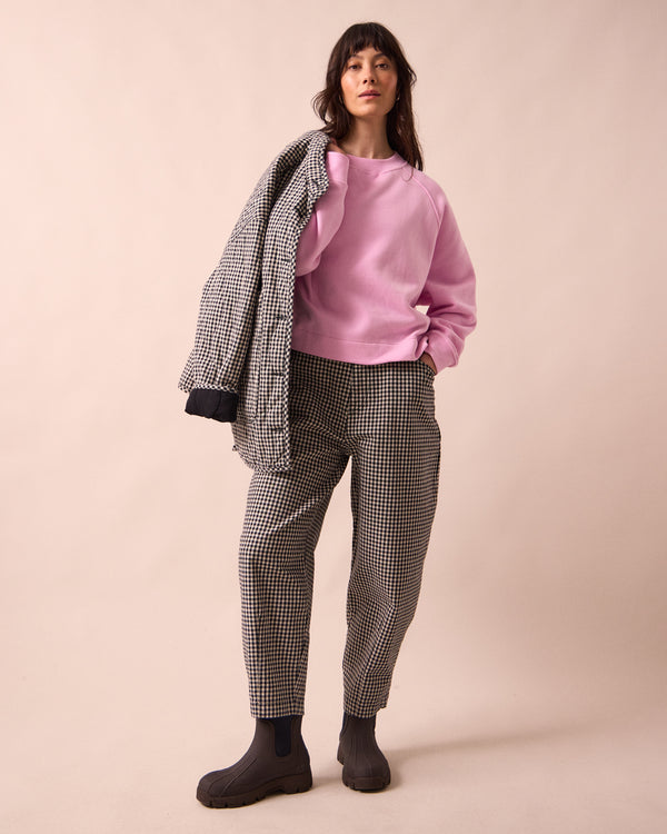 model wears remi black and white mini gingham denim jeans left