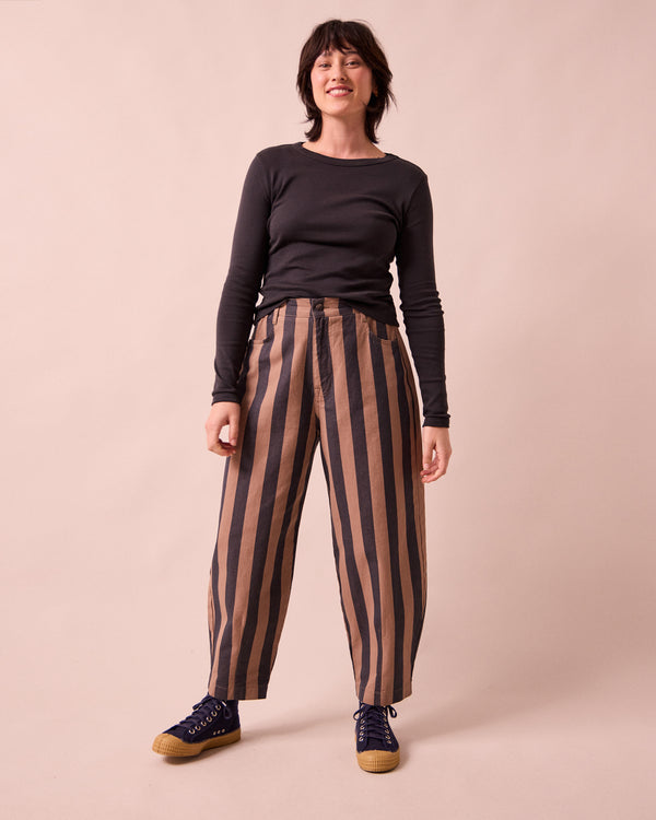 model wears remi graphite and mocha denim jeans right