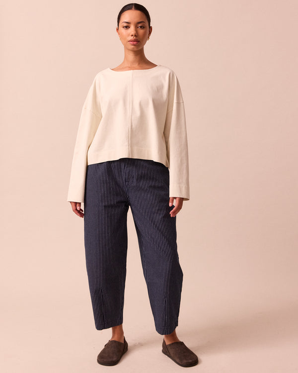 model wears remi navy pinstripe denim trousers front