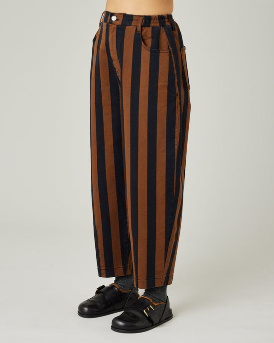 model wears black and rust stripe remi jeans left