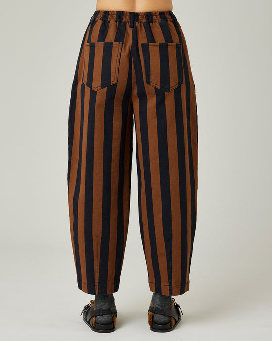 model wears black and rust stripe remi jeans 