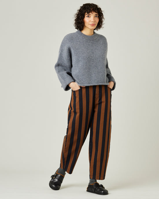 model wears black and rust stripe remi jeans 