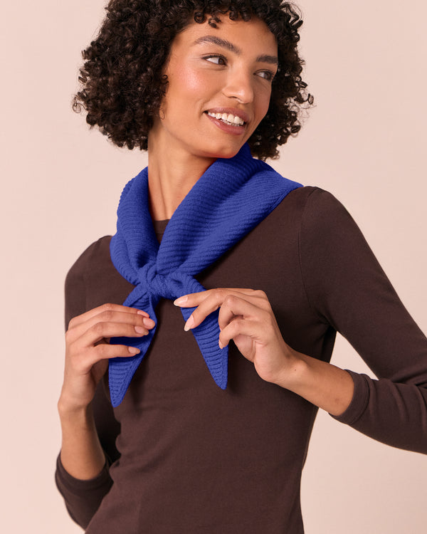 model wears klein blue ribbed knitted neckerchief