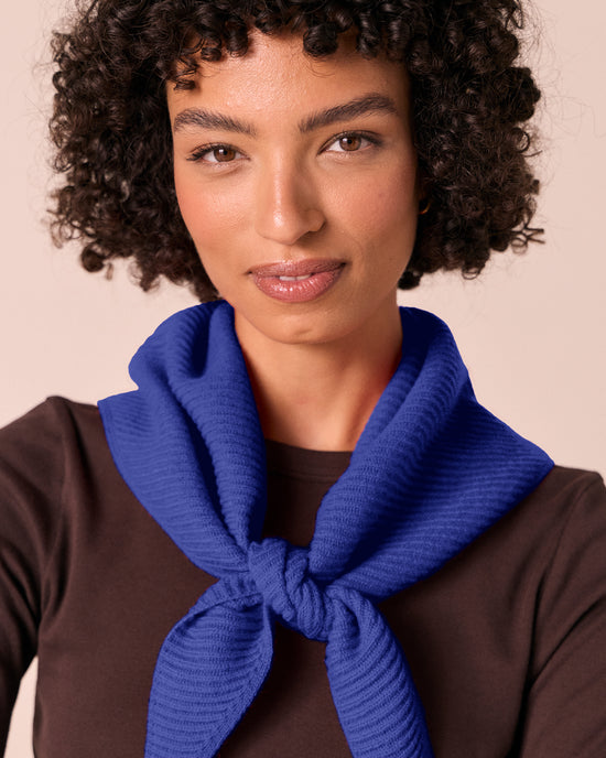 model wears klein blue ribbed knitted neckerchief