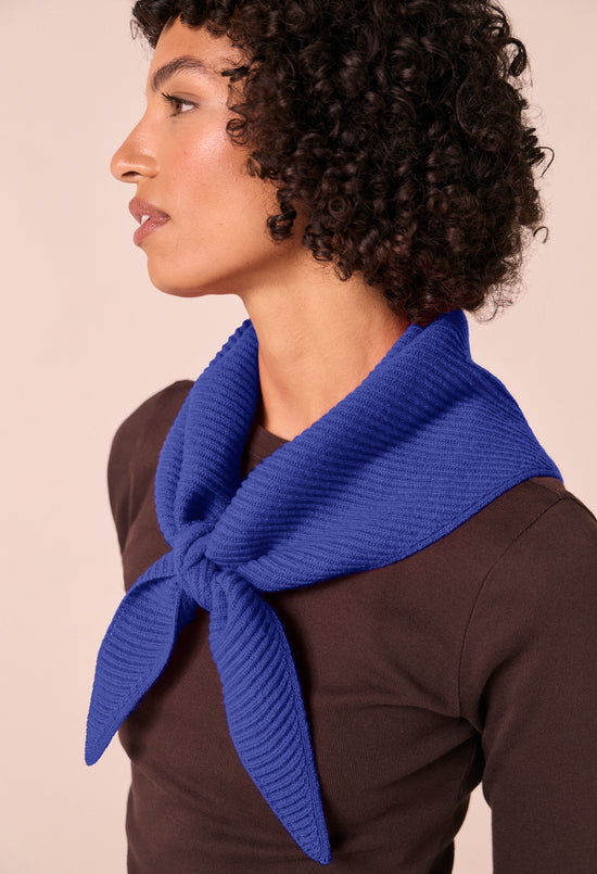 model wears klein blue ribbed knitted neckerchief