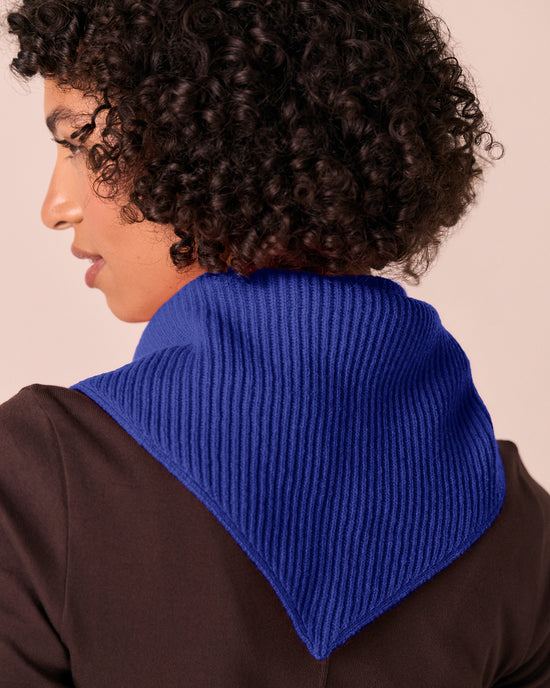 model wears klein blue ribbed knitted neckerchief