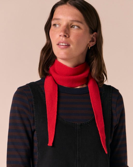 model wears ribbed poppy red knitted neckerchief