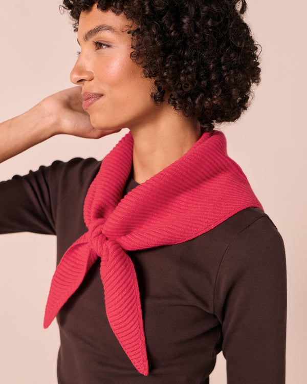 model wears ribbed rhubarb knitted neckerchief