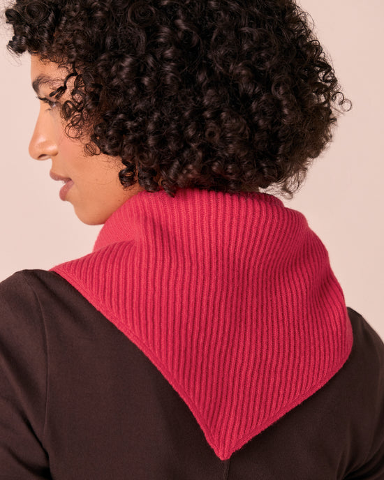 model wears ribbed rhubarb knitted neckerchief