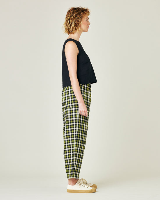 model wears olive black and ecru checked huxley trousers