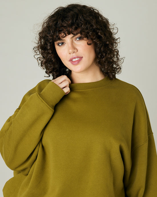 model wears olive green jersey riley jumper