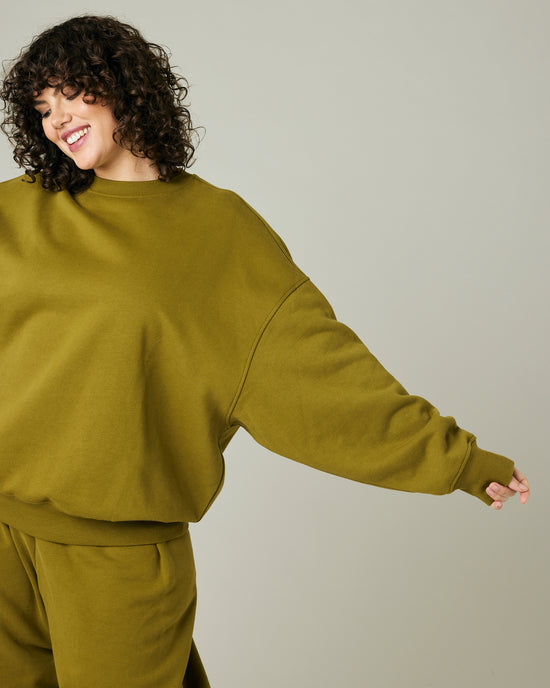 model wears olive green jersey riley jumper