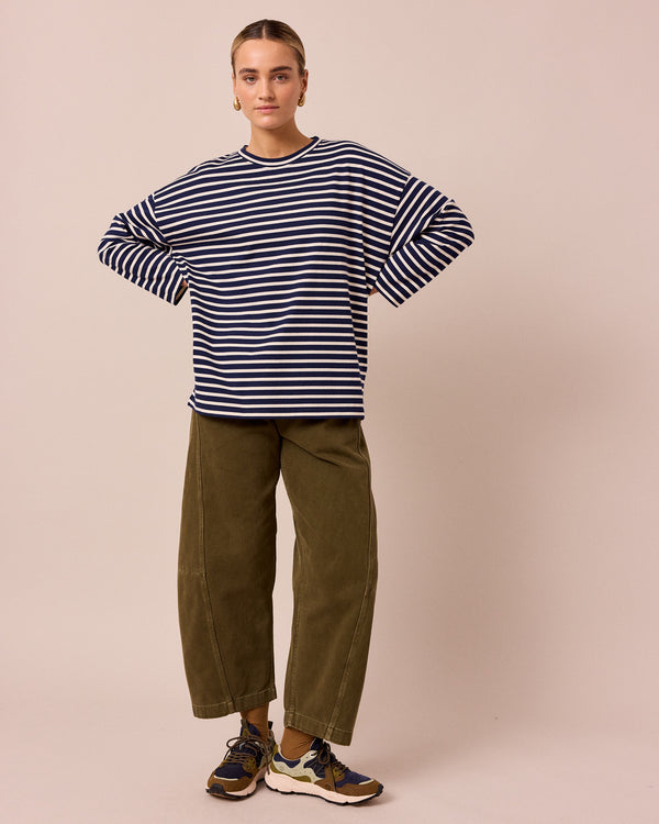 model wears tori olive denim jeans right