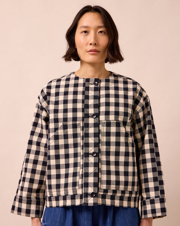 model wears rosa black and white check denim jacket