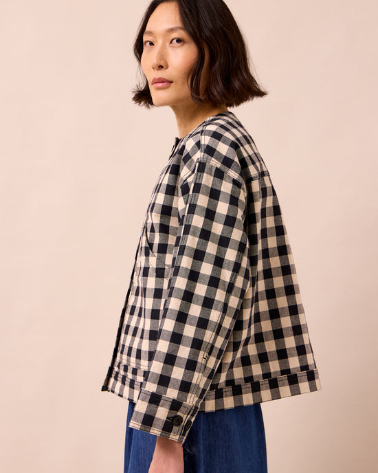model wears rosa black and white check denim jacket