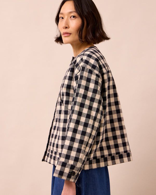 model wears rosa black and white check denim jacket