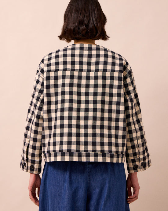model wears rosa black and white check denim jacket