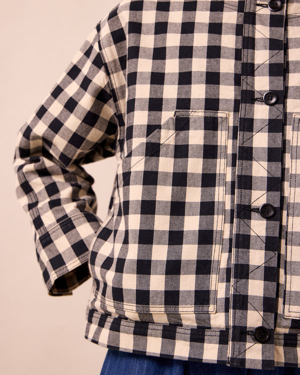 model wears rosa black and white check denim jacket