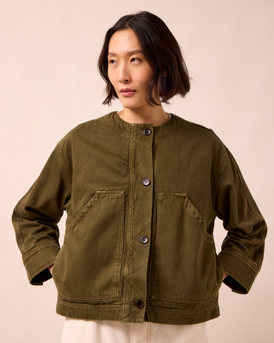 model wears rosa olive denim jacket