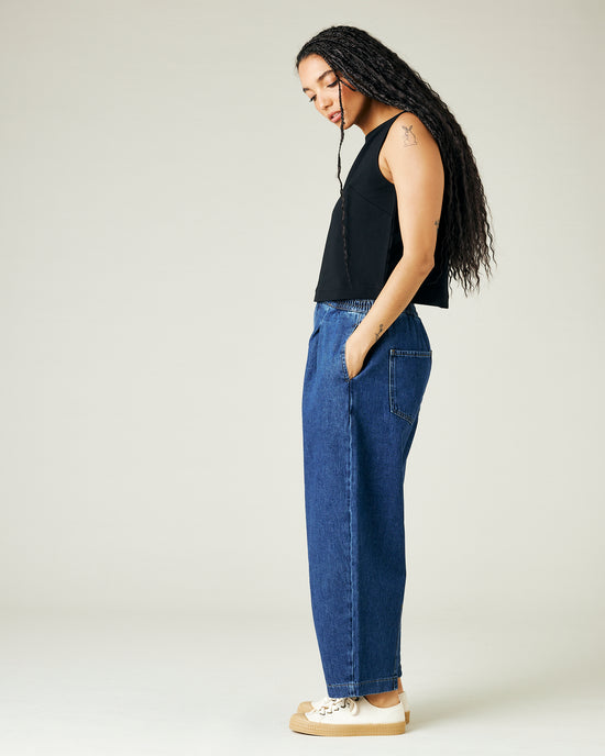 model wears mid wash blue denim rowan jeans 