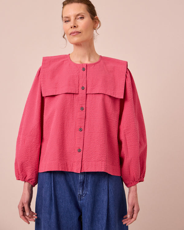 model wears rowen raspberry stripe seersucker top