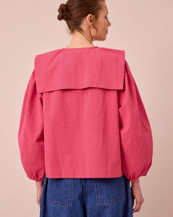 model wears rowen raspberry stripe seersucker top