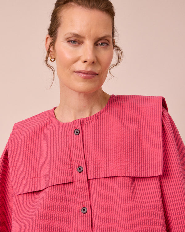 model wears rowen raspberry stripe seersucker top