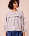 model wears rowen blue and ecru stripe seersucker top