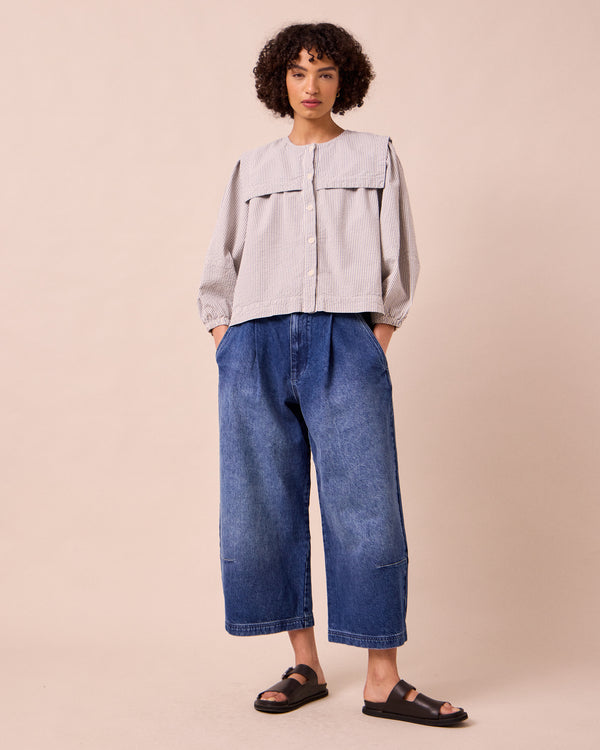 model wears rowen blue and ecru stripe seersucker top