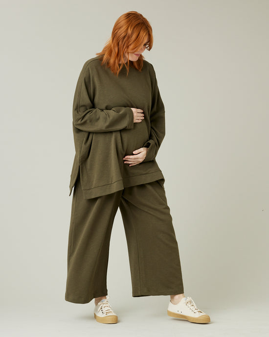 pregnant model wears olive jersey ruby trousers