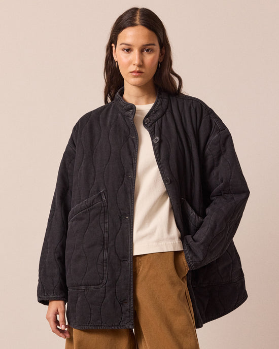 model wears rue black quilted jacket