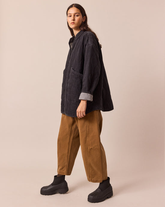 model wears rue black quilted jacket