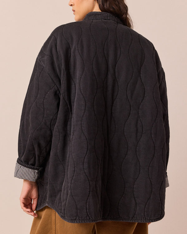 model wears rue black quilted jacket