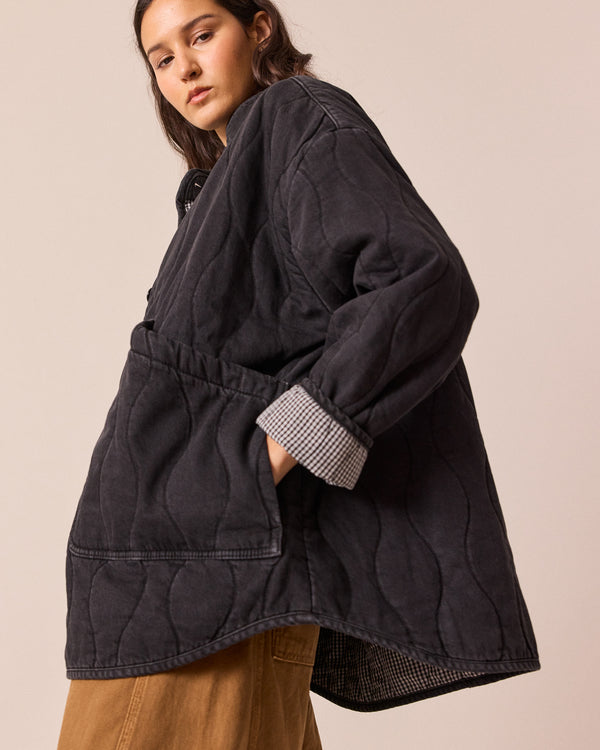 model wears rue black quilted jacket