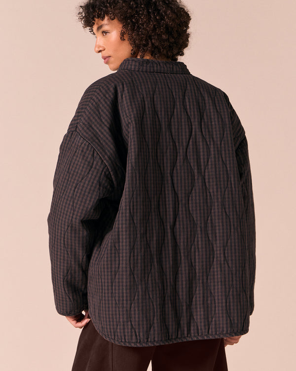model wears rue dark mulberry gingham quilted denim jacket