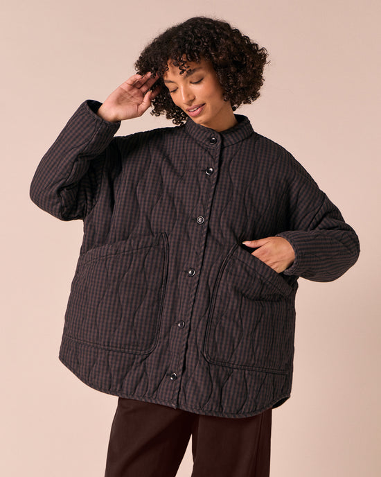 model wears rue dark mulberry gingham quilted denim jacket