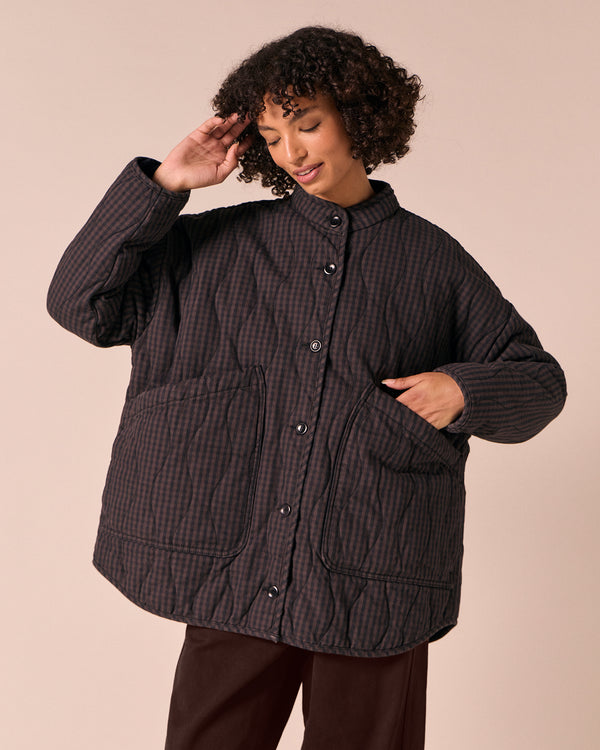 model wears rue dark mulberry gingham quilted denim jacket