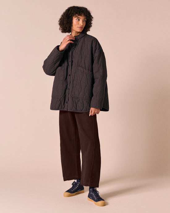 model wears rue dark mulberry gingham quilted denim jacket